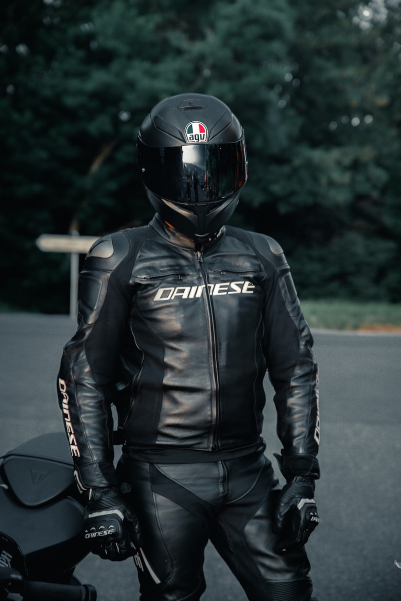 man in black leather jacket wearing black helmet